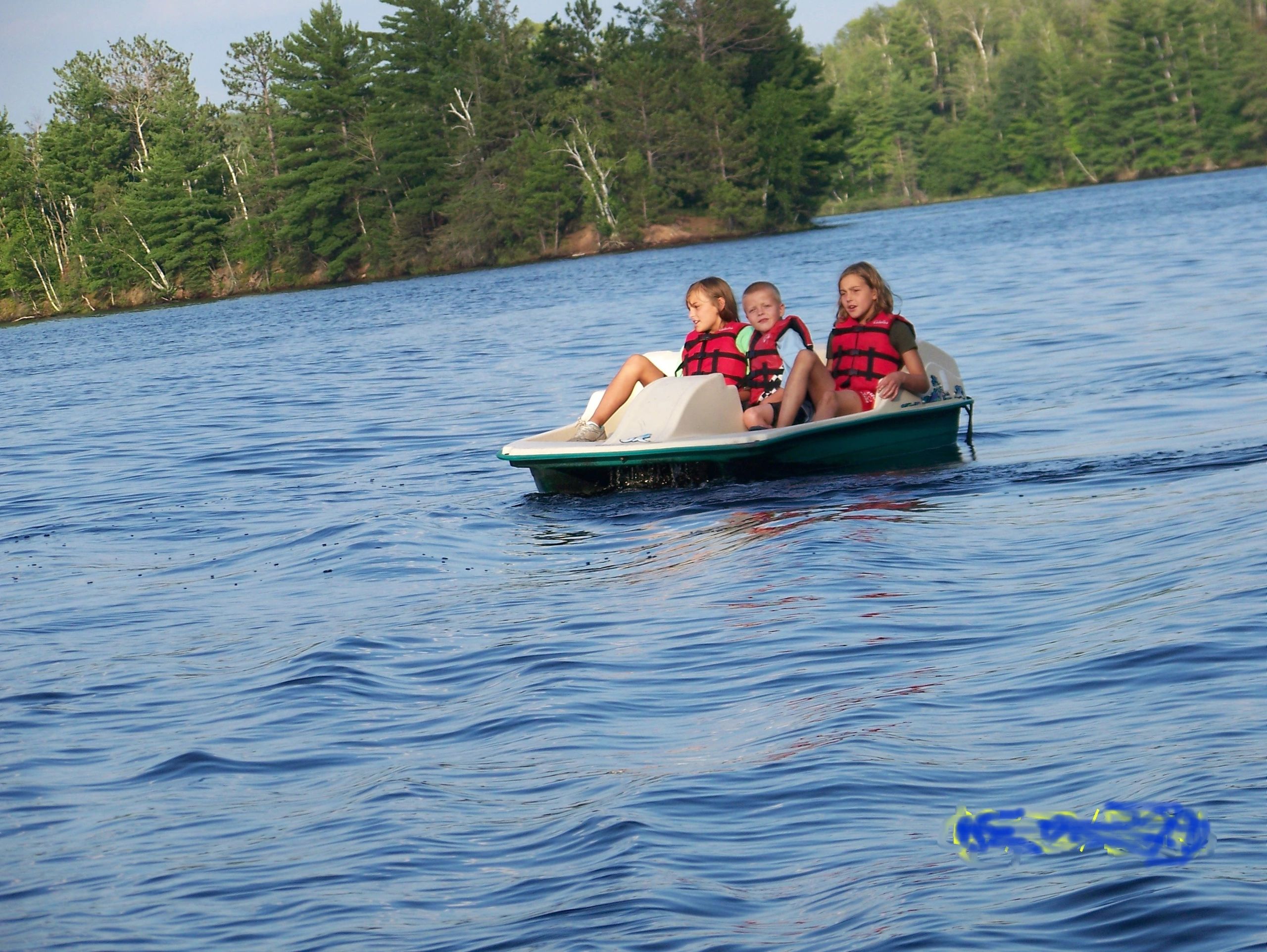 Children in life jackets on the lake