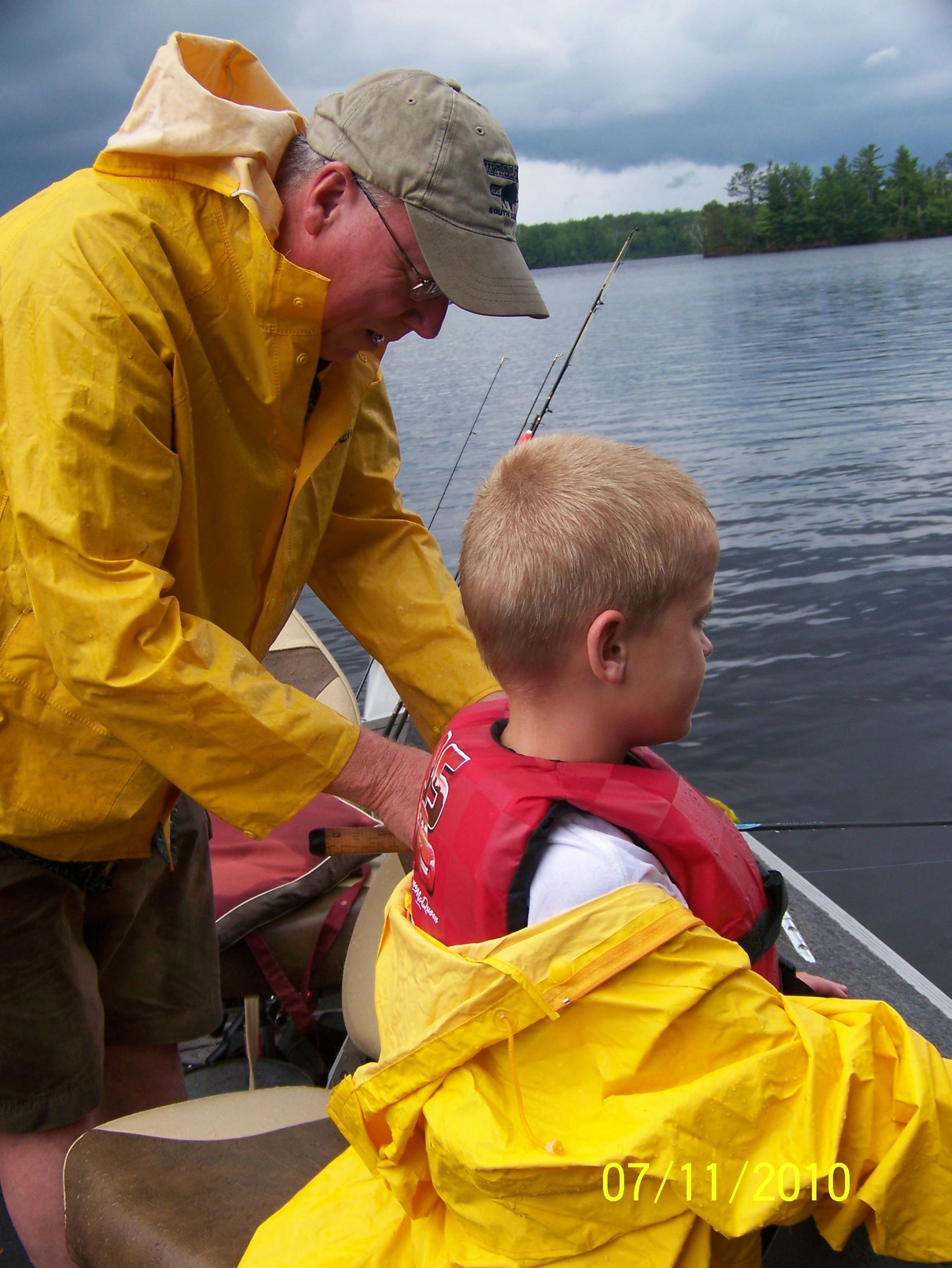 Teaching a child to fish on the lake